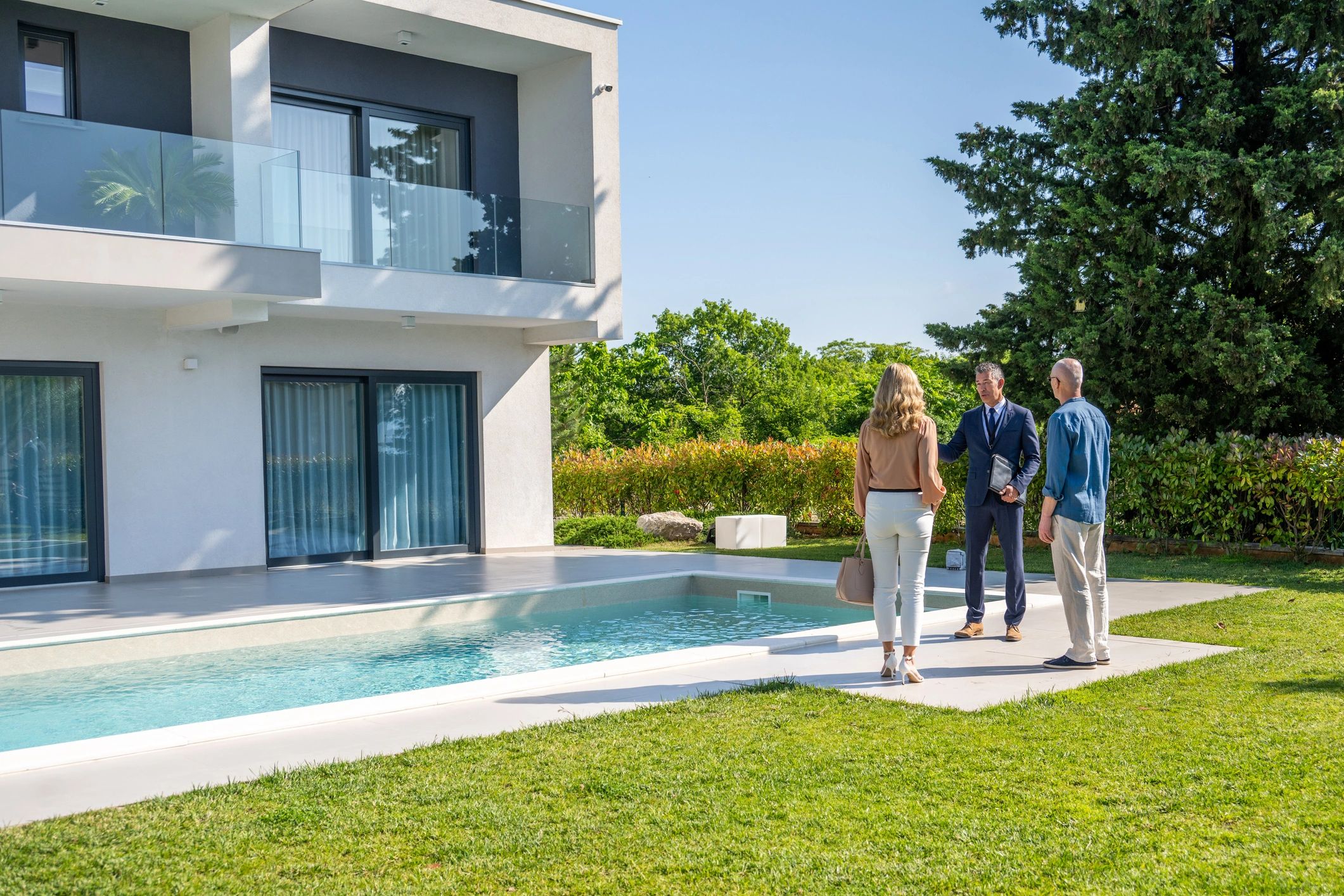 Real estate agent showing a modern home to clients